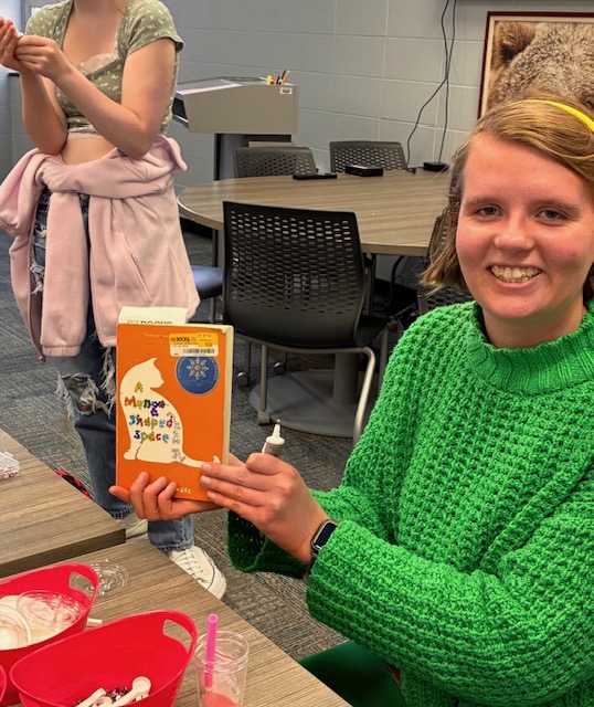 Dolores White, a Senior, bedazzling her book!